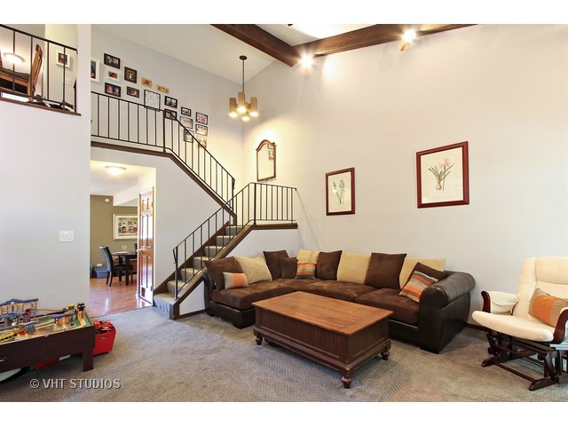 492 Rustic Drive, Unit 492 Wheeling, IL 60090 - Photo 3 of 20 a living room with furniture and a potted plant