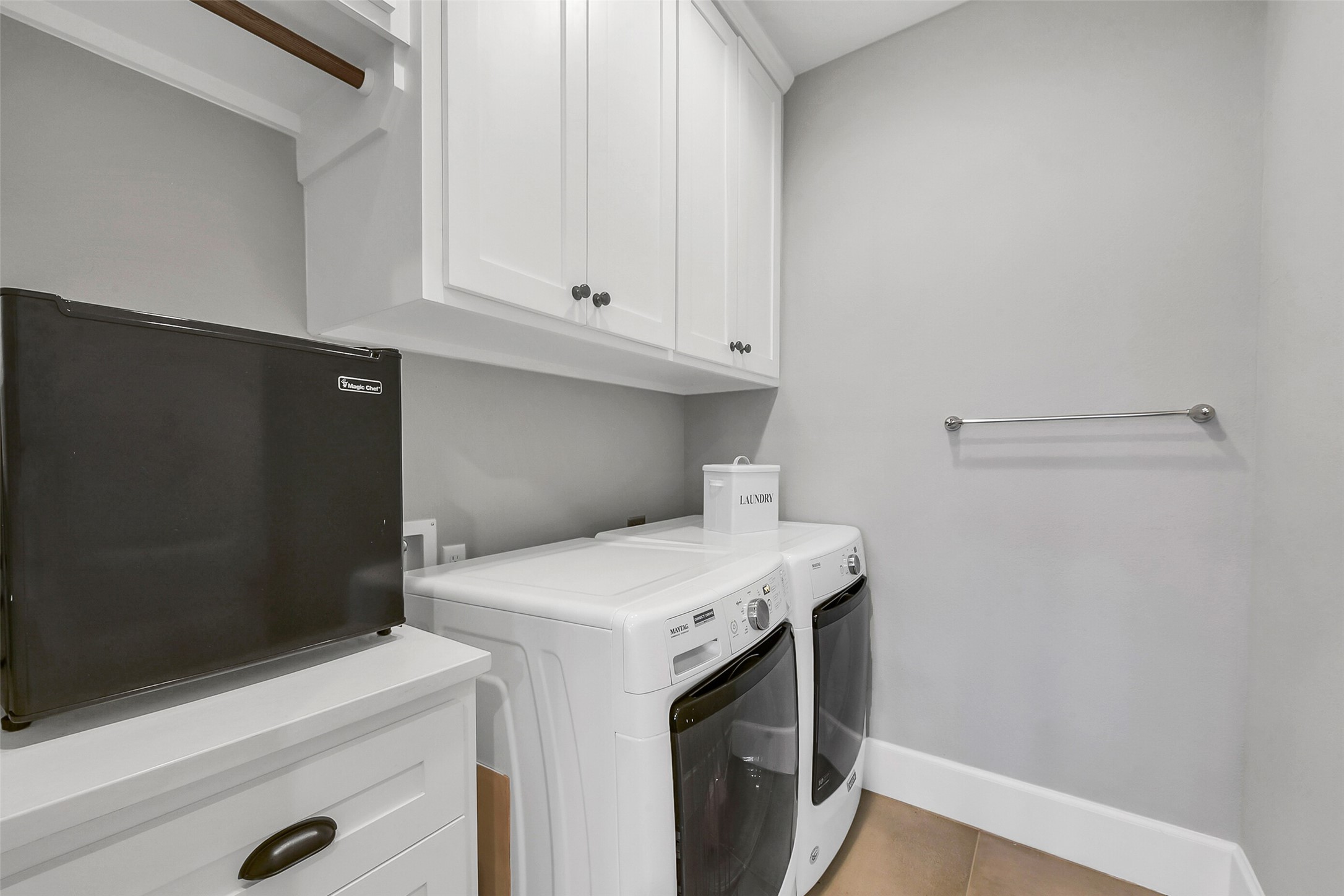 508 East 25th Street Houston, TX 77008 - Photo 23 of 45 A functional laundry room, located off the game room, with upper cabinets and towel rack. This area makes up 1 of 3 total washer and dryer combinations throughout the property.