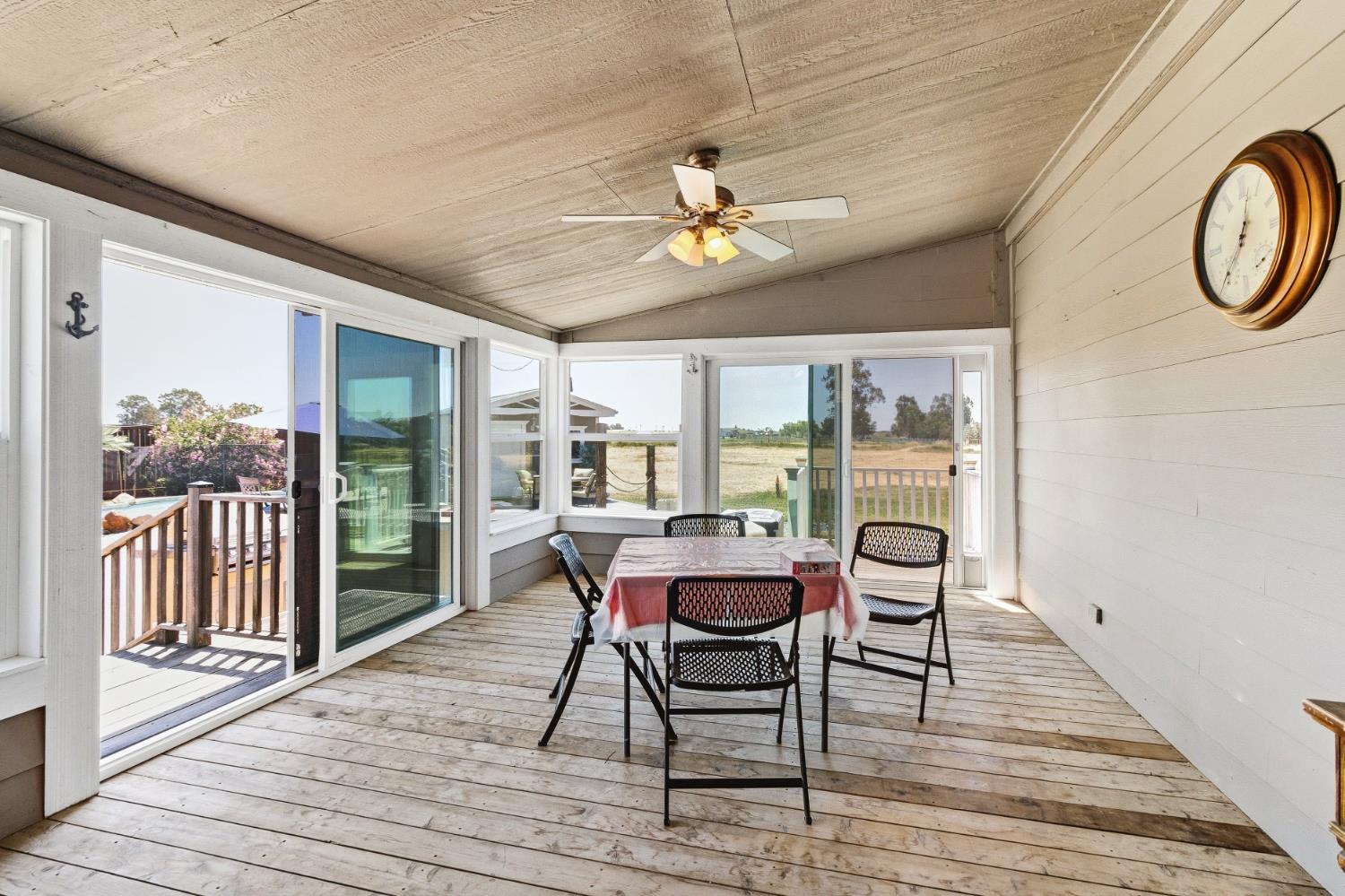 12390 Hobday Road Wilton, CA 95693 - Photo 44 of 92 a view of a dining room with furniture window and wooden floor