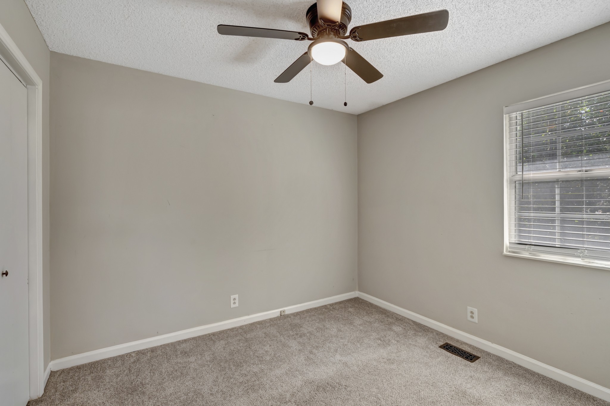 1060 Jacksons Valley Road Hermitage, TN 37076 - Photo 15 of 19 an empty room with a window and a fan