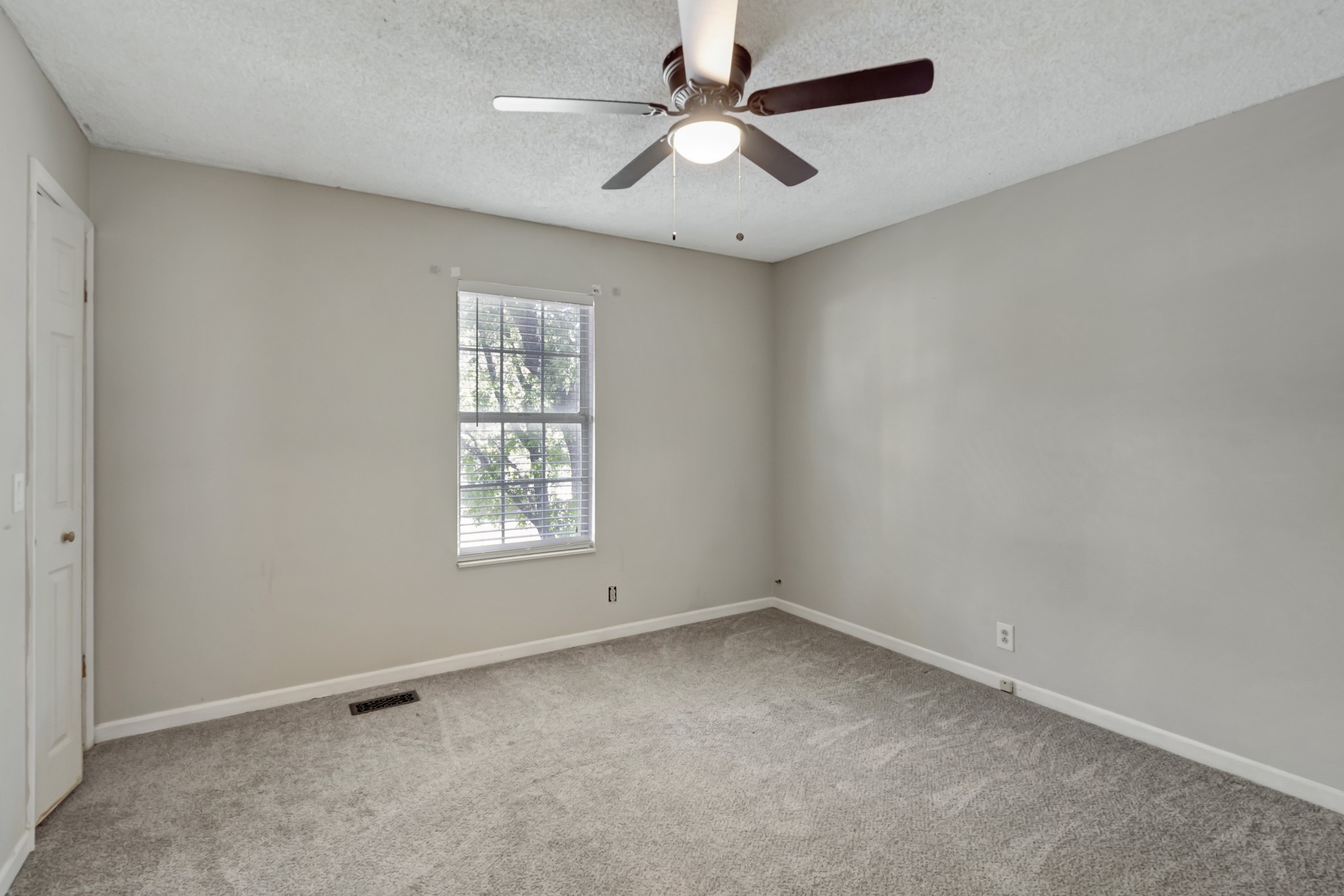 1060 Jacksons Valley Road Hermitage, TN 37076 - Photo 17 of 19 an empty room with a window and a fan