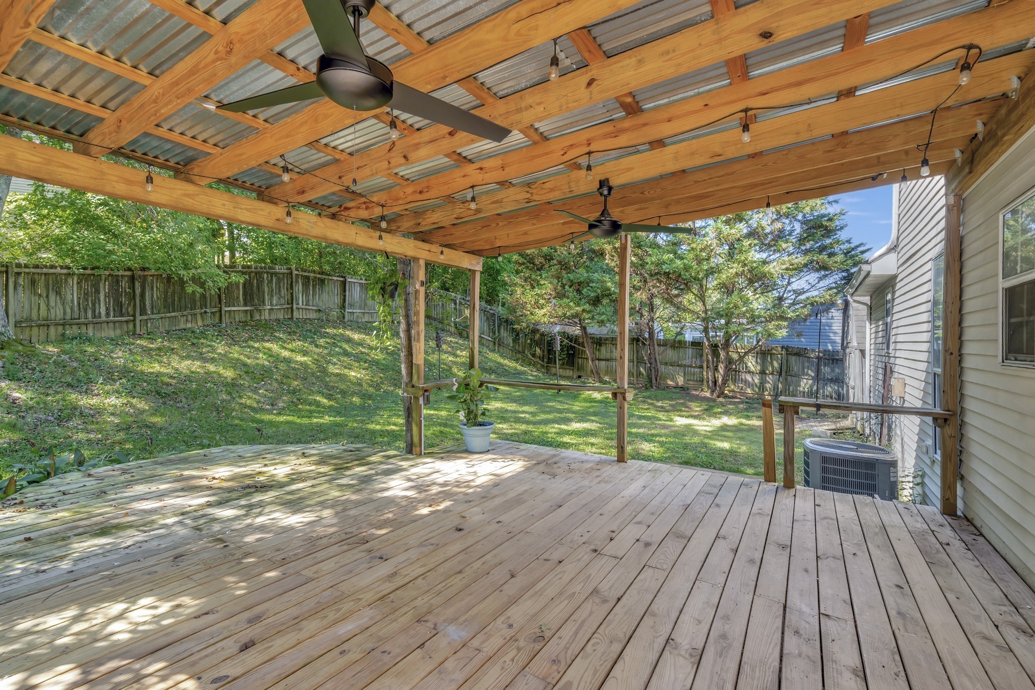 1060 Jacksons Valley Road Hermitage, TN 37076 - Photo 18 of 19 a view of a backyard with wooden floor and floor to ceiling window