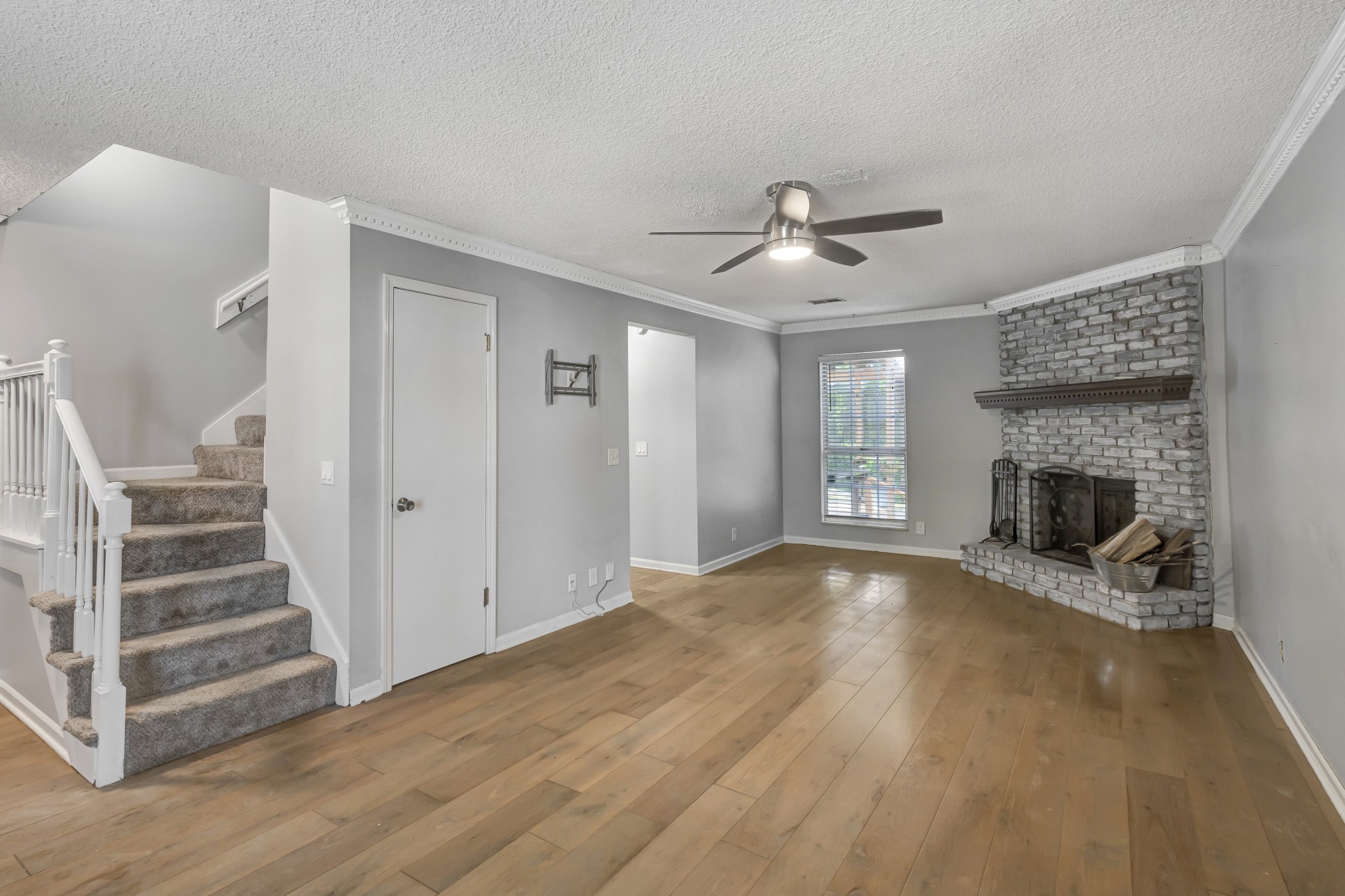 1060 Jacksons Valley Road Hermitage, TN 37076 - Photo 4 of 19 a view of an empty room with wooden floor fireplace and a window