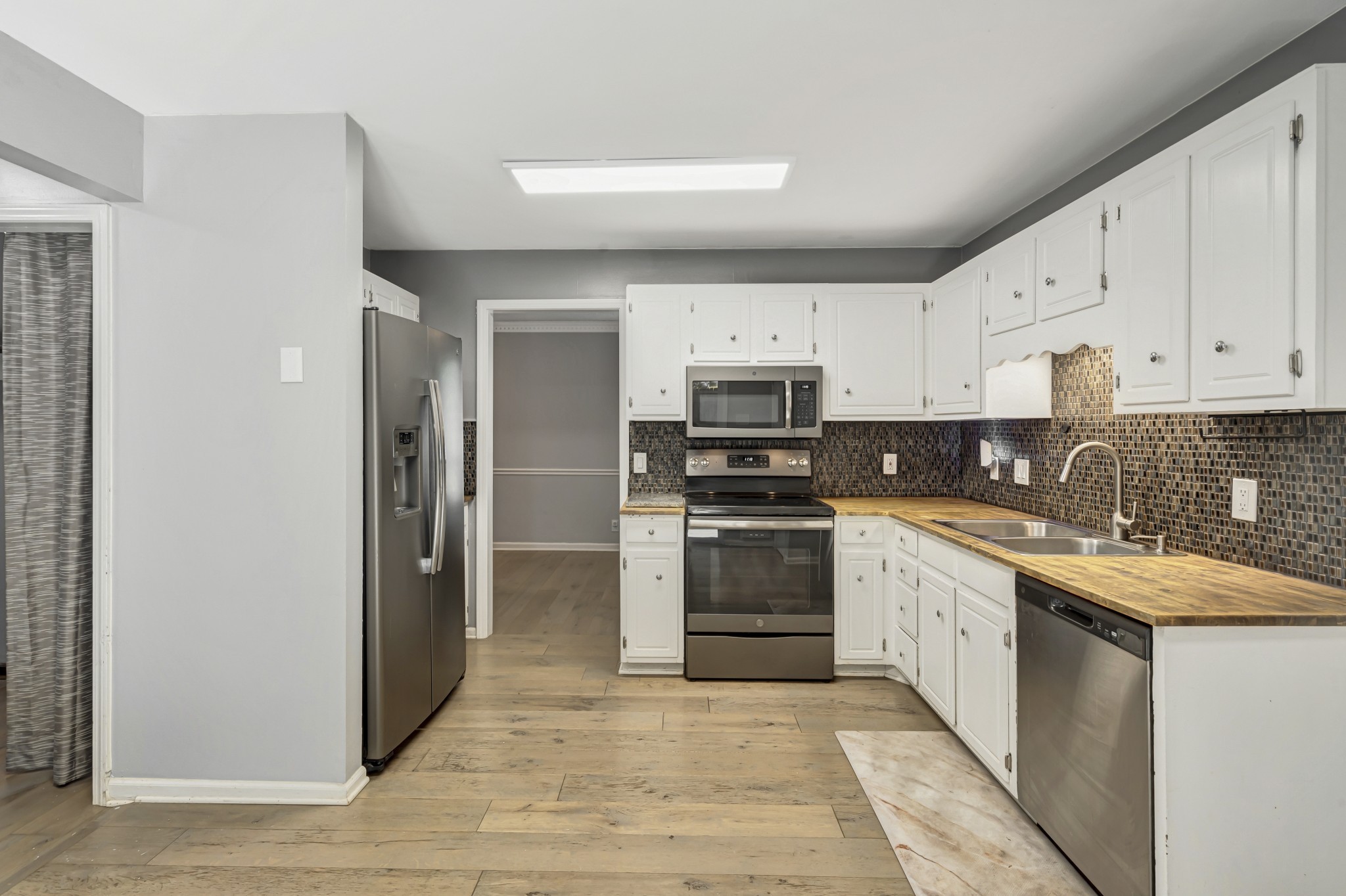 1060 Jacksons Valley Road Hermitage, TN 37076 - Photo 7 of 19 a kitchen with stainless steel appliances granite countertop a refrigerator and a stove top oven