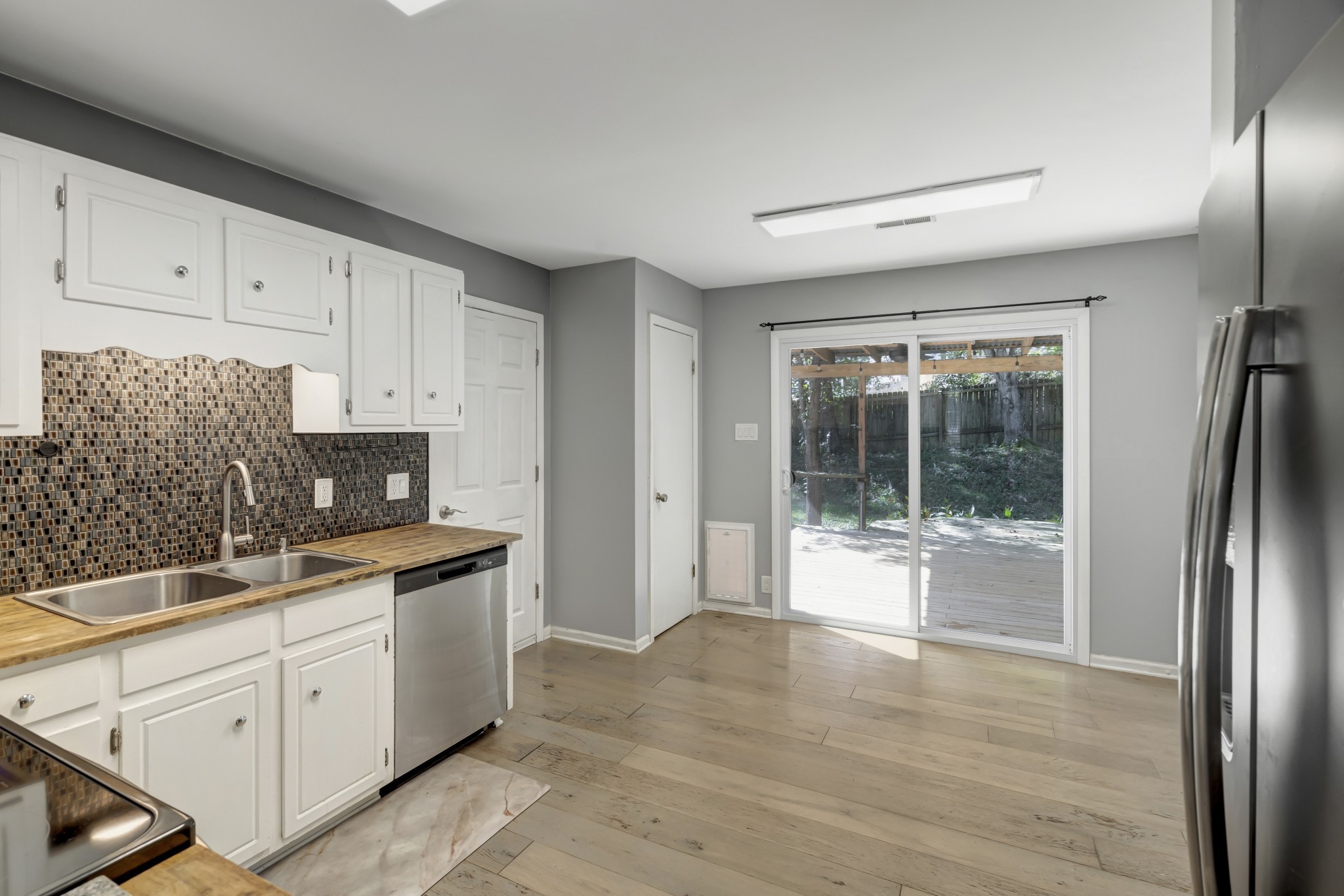 1060 Jacksons Valley Road Hermitage, TN 37076 - Photo 8 of 19 a kitchen with a refrigerator and white cabinets