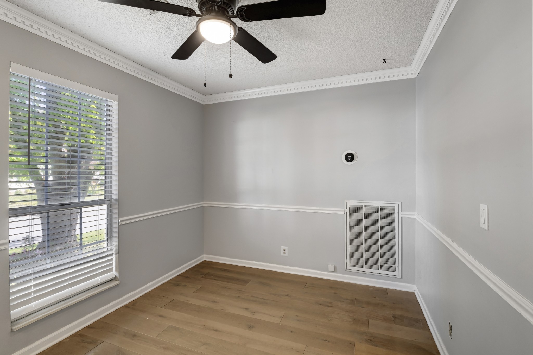 1060 Jacksons Valley Road Hermitage, TN 37076 - Photo 10 of 19 a view of an empty room with a window and wooden floor