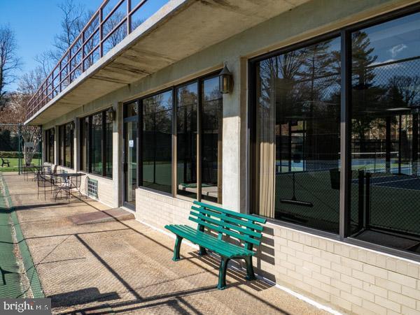 5225 Pooks Hill Road, Unit 120N Bethesda, MD 20814 - Photo 13 of 18 Sunlit patio with inviting green bench.
