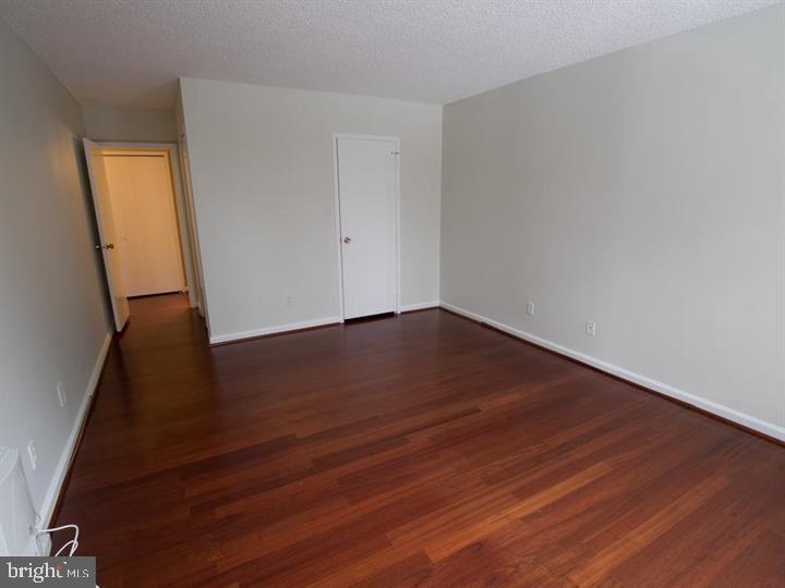 5225 Pooks Hill Road, Unit 120N Bethesda, MD 20814 - Photo 5 of 18 Spacious room with warm wood flooring.