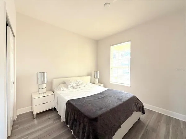 a bed room with a bed and a window