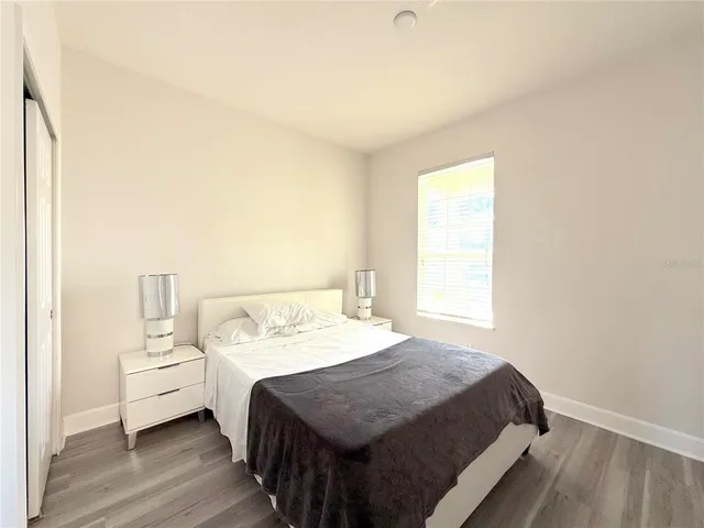 a bed room with a bed and a window