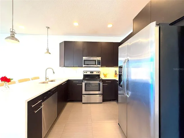 a kitchen with stainless steel appliances granite countertop a sink and stove top oven
