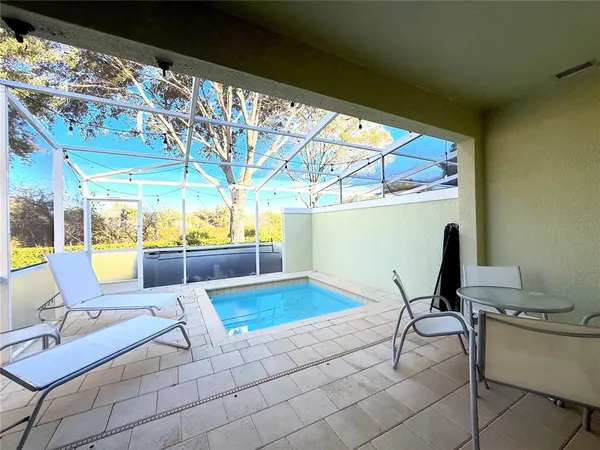 a view of a chairs and table in patio