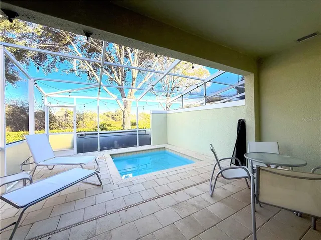 a view of a chairs and table in patio