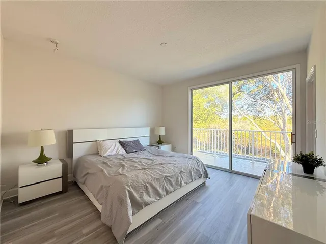a bedroom with a bed and a large window