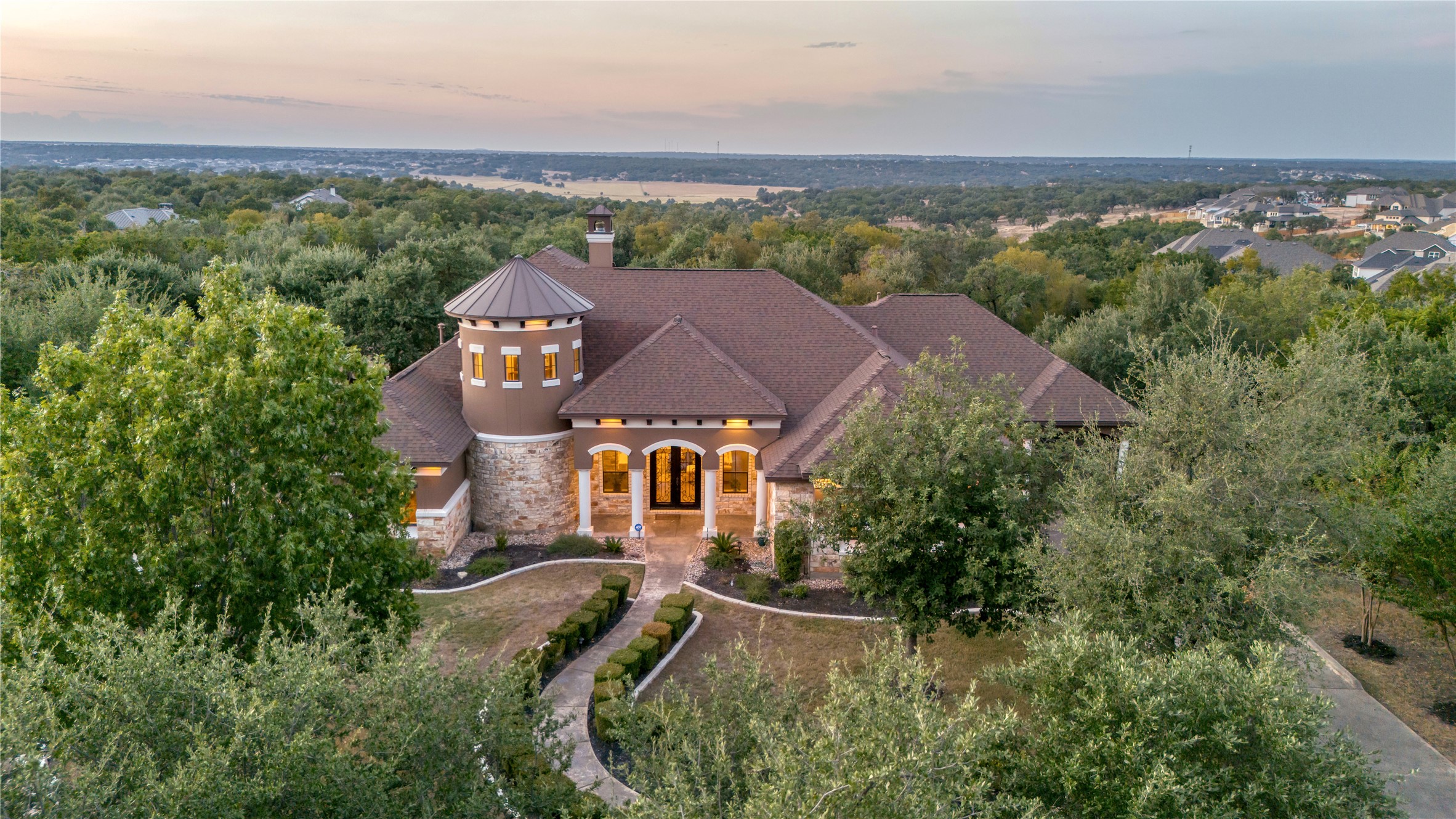 an aerial view of a house with a mountain