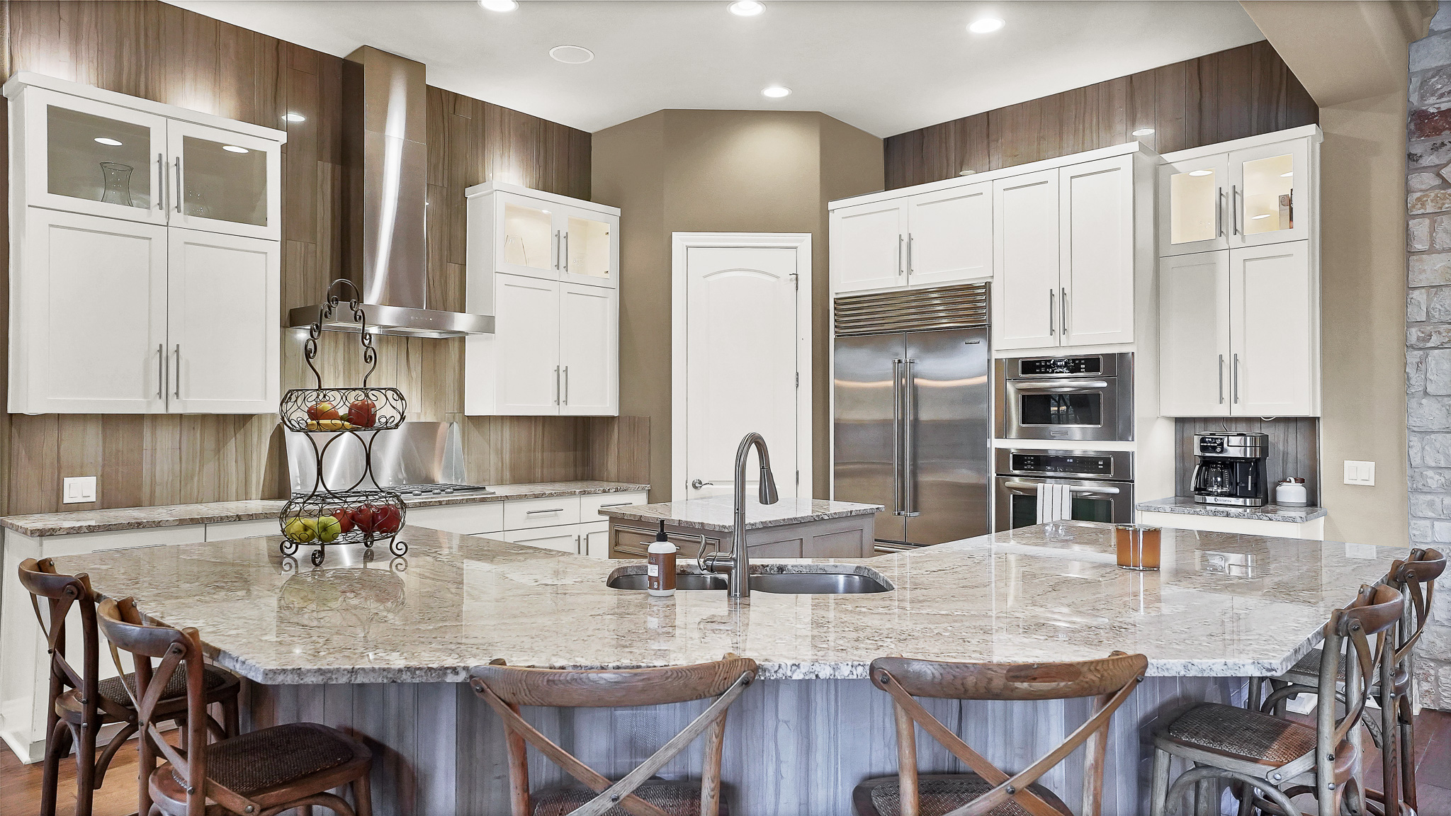 409 Escalera Parkway Georgetown, TX 78628 - Photo 11 of 40 a kitchen with stainless steel appliances granite countertop a kitchen island a stove a table and chairs
