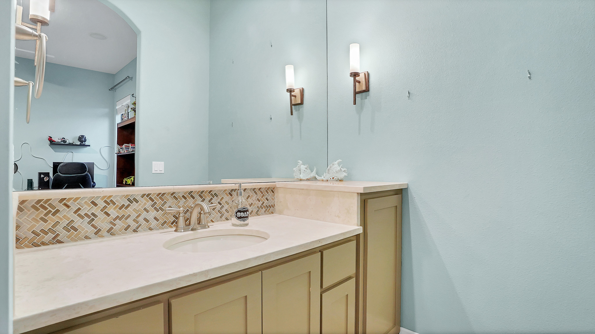 409 Escalera Parkway Georgetown, TX 78628 - Photo 17 of 40 a bathroom with a sink and a mirror