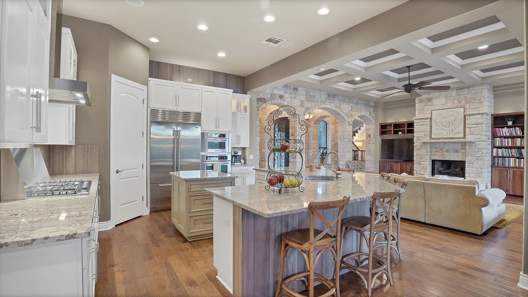 409 Escalera Parkway Georgetown, TX 78628 - Photo 40 of 40 a kitchen with stainless steel appliances kitchen island granite countertop a refrigerator a stove a sink a dining table and chairs with wooden floor