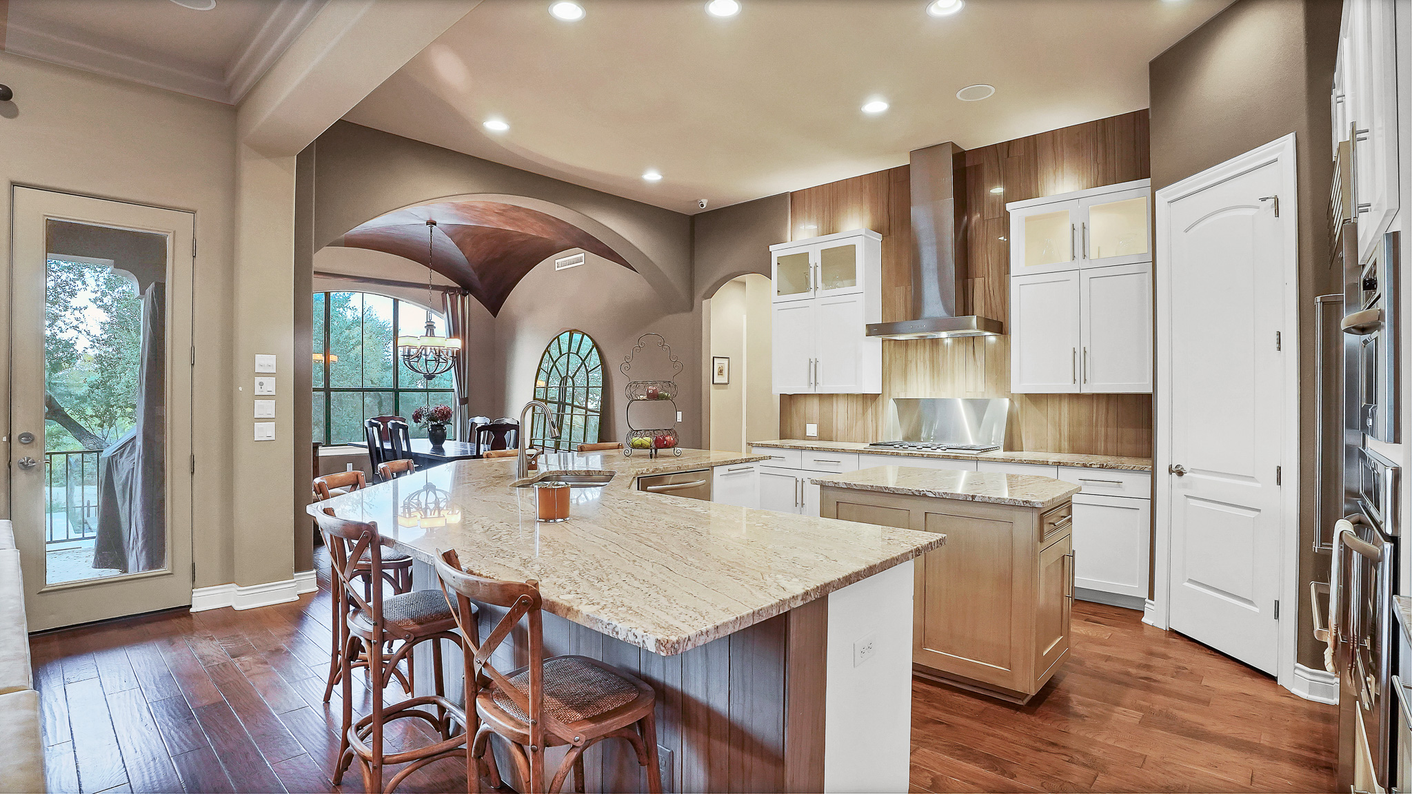 409 Escalera Parkway Georgetown, TX 78628 - Photo 5 of 40 a kitchen with stainless steel appliances granite countertop furniture wooden floor and a refrigerator