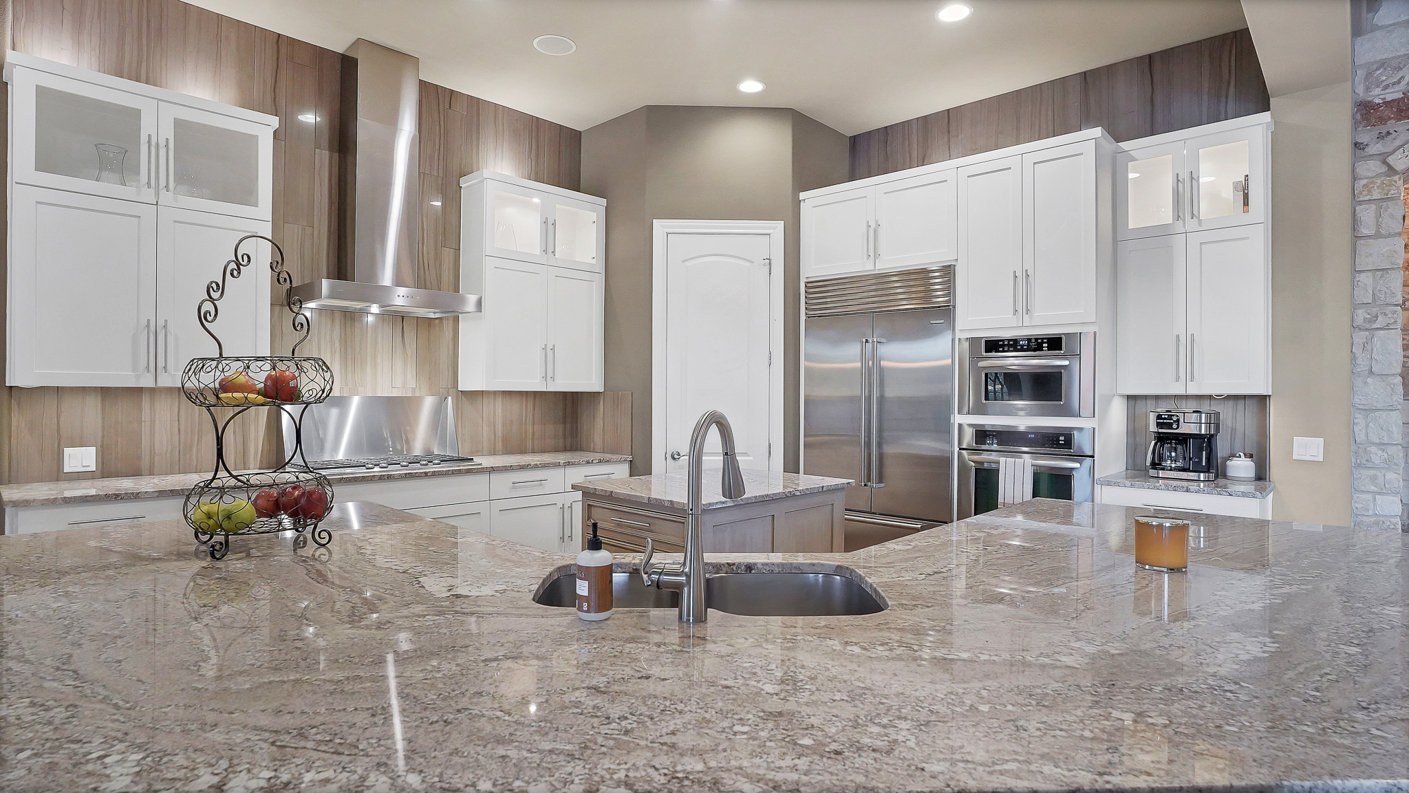 409 Escalera Parkway Georgetown, TX 78628 - Photo 8 of 40 a kitchen with stainless steel appliances granite countertop a sink refrigerator and cabinets