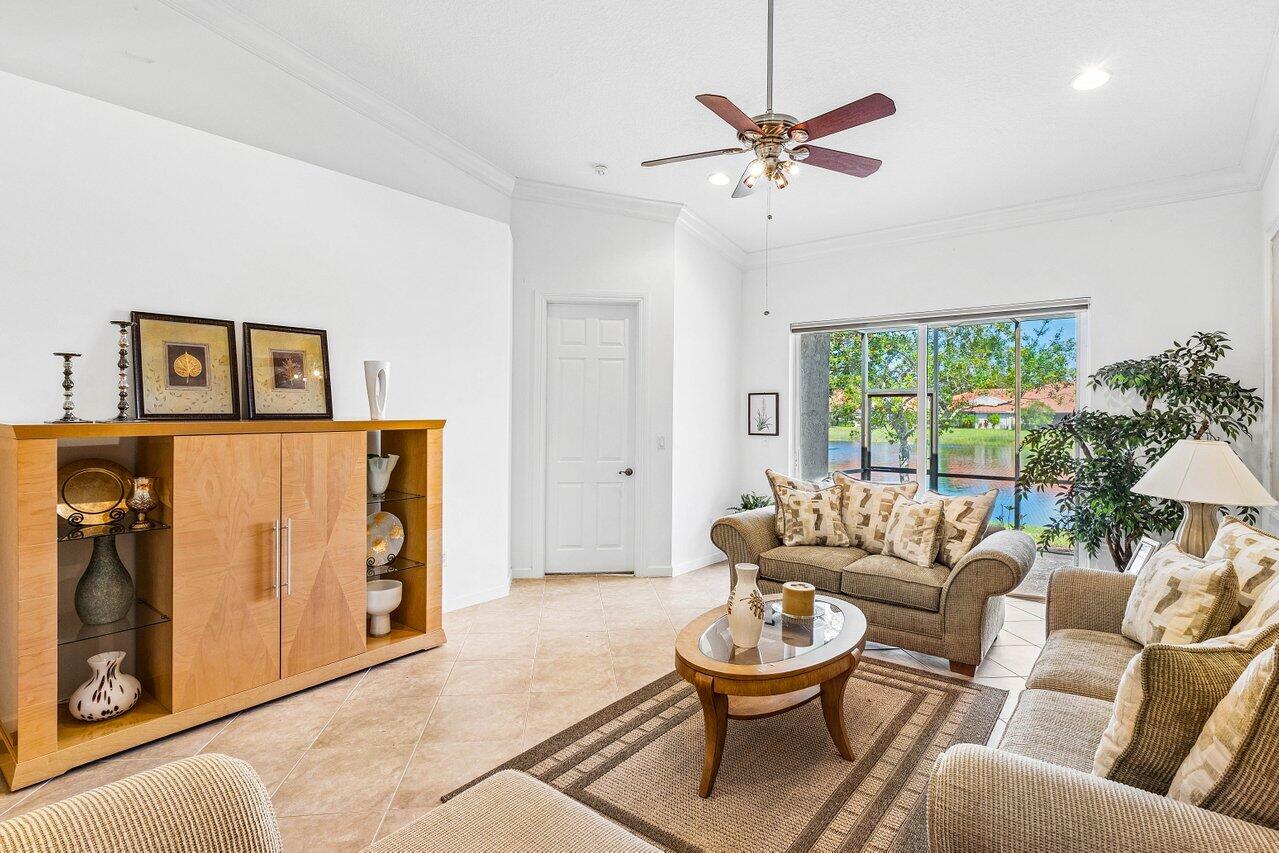 23069 Addison Lakes Circle Boca Raton, FL 33433 - Photo 11 of 26 a living room with furniture and a large window
