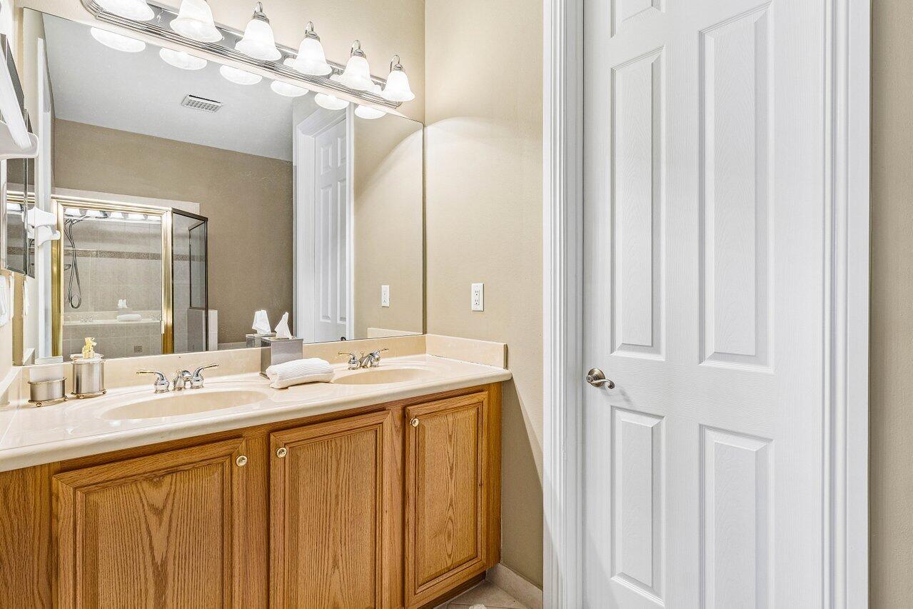 23069 Addison Lakes Circle Boca Raton, FL 33433 - Photo 13 of 26 a bathroom with a double vanity sink and a mirror