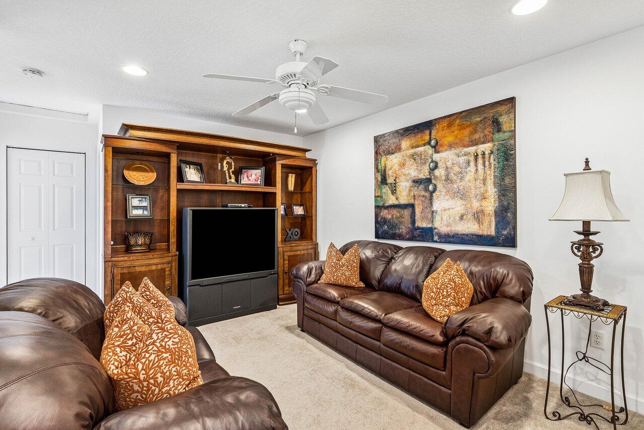 23069 Addison Lakes Circle Boca Raton, FL 33433 - Photo 15 of 26 a living room with furniture a fireplace and a flat screen tv