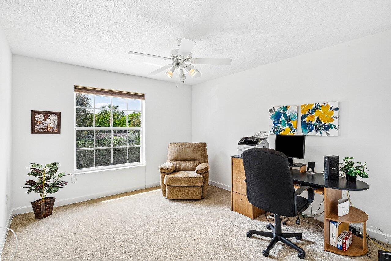 23069 Addison Lakes Circle Boca Raton, FL 33433 - Photo 16 of 26 a work room with furniture and a window