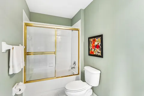 a bathroom with a toilet and a shower