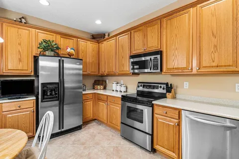 a kitchen with stainless steel appliances granite countertop a refrigerator stove microwave and sink