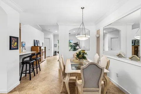a view of a dining room with furniture and chandelier