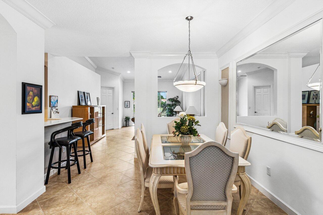 23069 Addison Lakes Circle Boca Raton, FL 33433 - Photo 8 of 26 a view of a dining room with furniture and chandelier