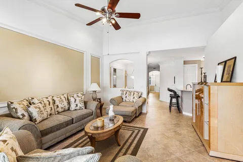 a living room with furniture and a dining table