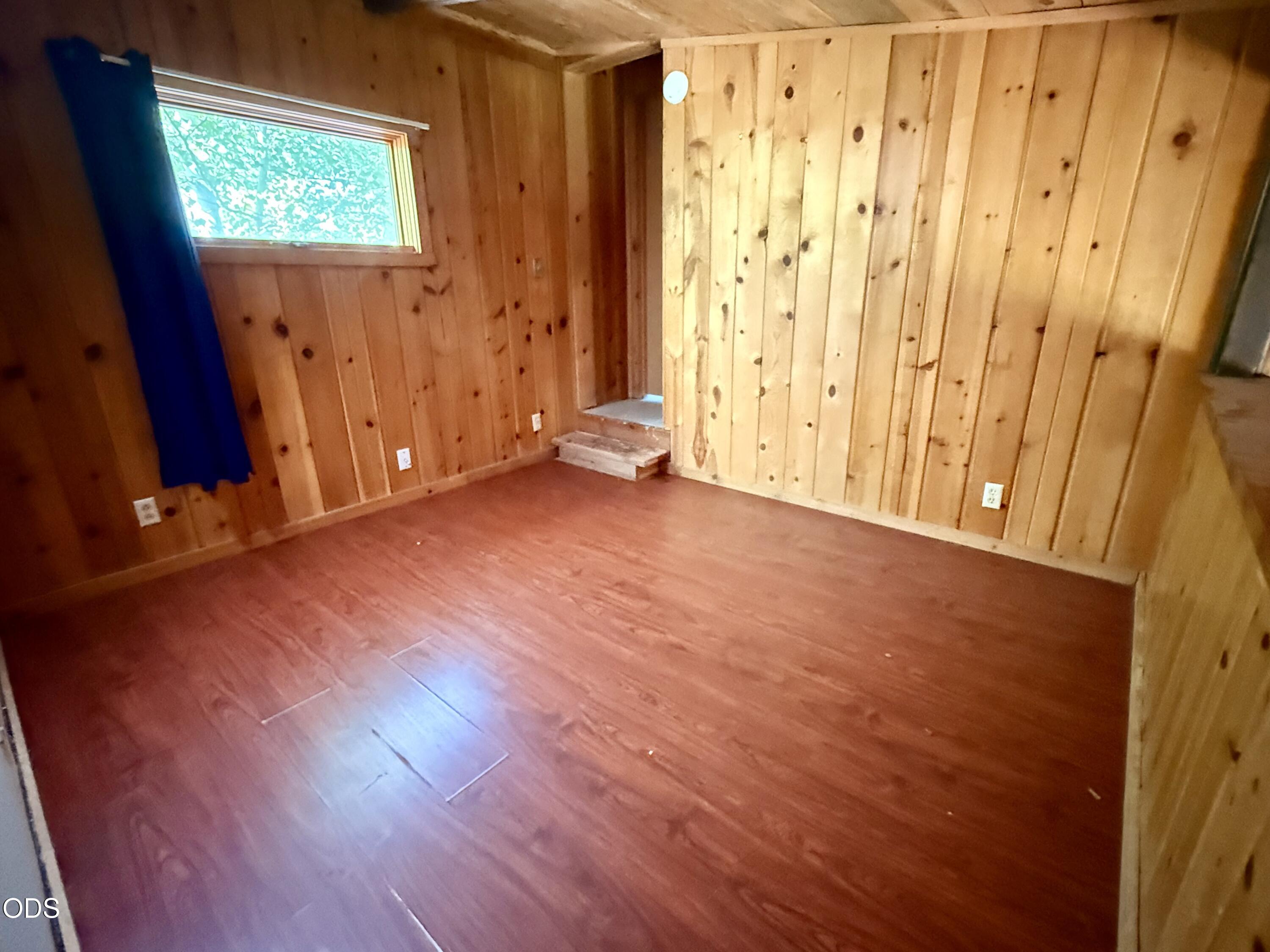 16025 Strawn Road La Pine, OR 97739 - Photo 38 of 95 a view of an empty room with wooden floor and a window