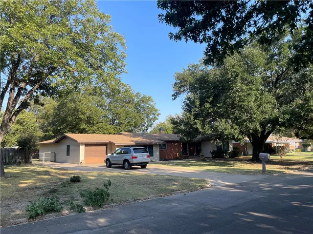 a view of a house with a large tree