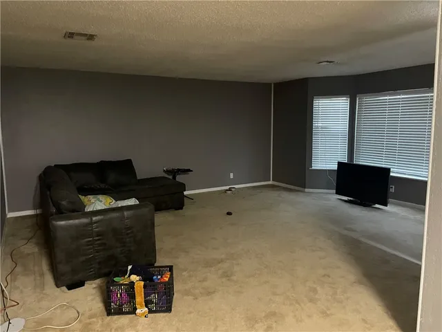 a room with furniture and flat screen tv