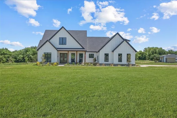 a front view of house with yard and green space