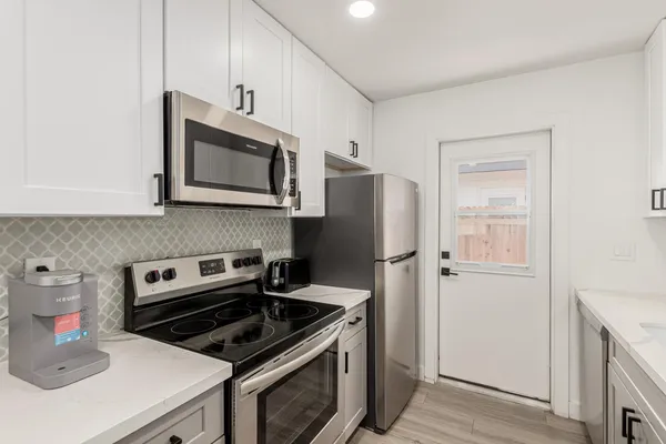 a kitchen with a refrigerator stove and microwave