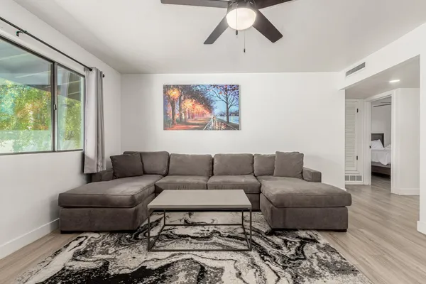 a living room with furniture and a large window