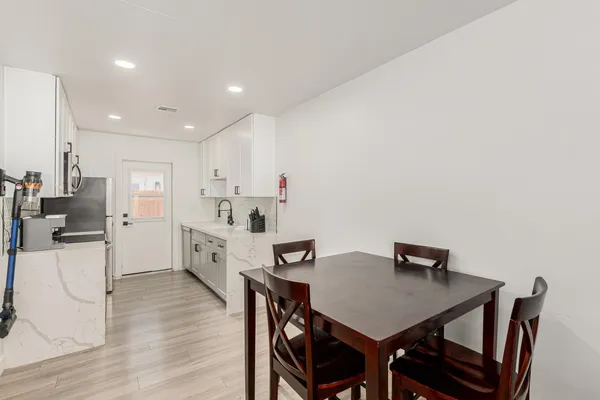 a view of a dining room with furniture and wooden floor