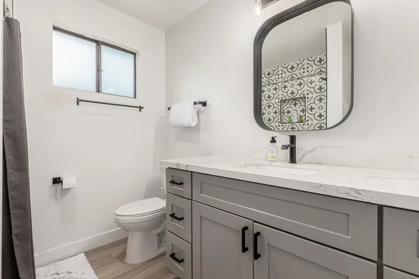 a view of bathroom with a toilet sink and mirror