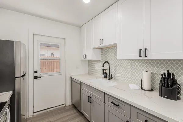 a kitchen with sink cabinets and window