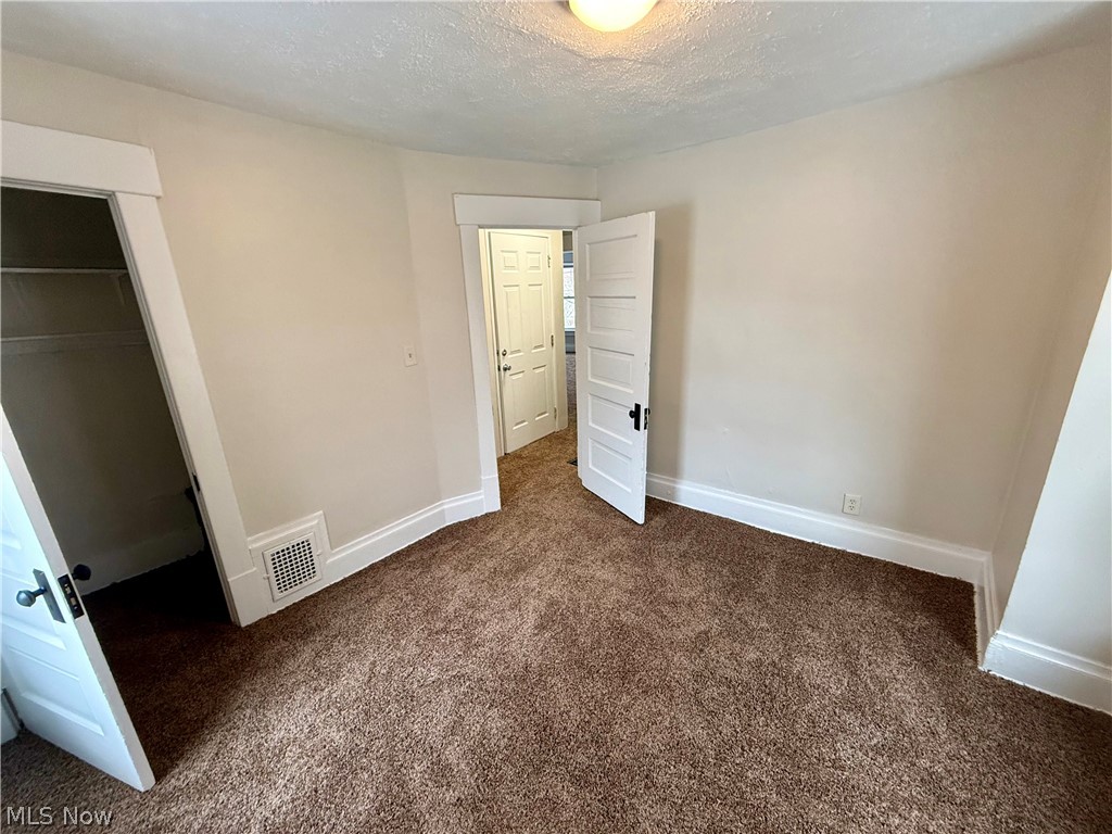 39 North Balch Street Akron, OH 44303 - Photo 14 of 19 Unfurnished bedroom featuring dark colored carpet and a textured ceiling