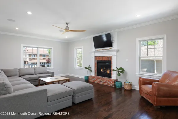 a living room with furniture fireplace and window