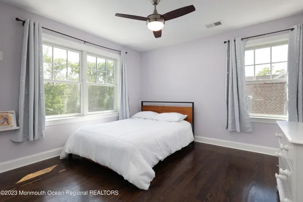 a bedroom with a large bed and a window