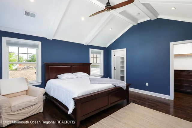 a bedroom with a large bed and a large window