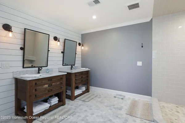 a bathroom with a double vanity sink and a mirror