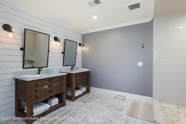 a bathroom with a double vanity sink and a mirror