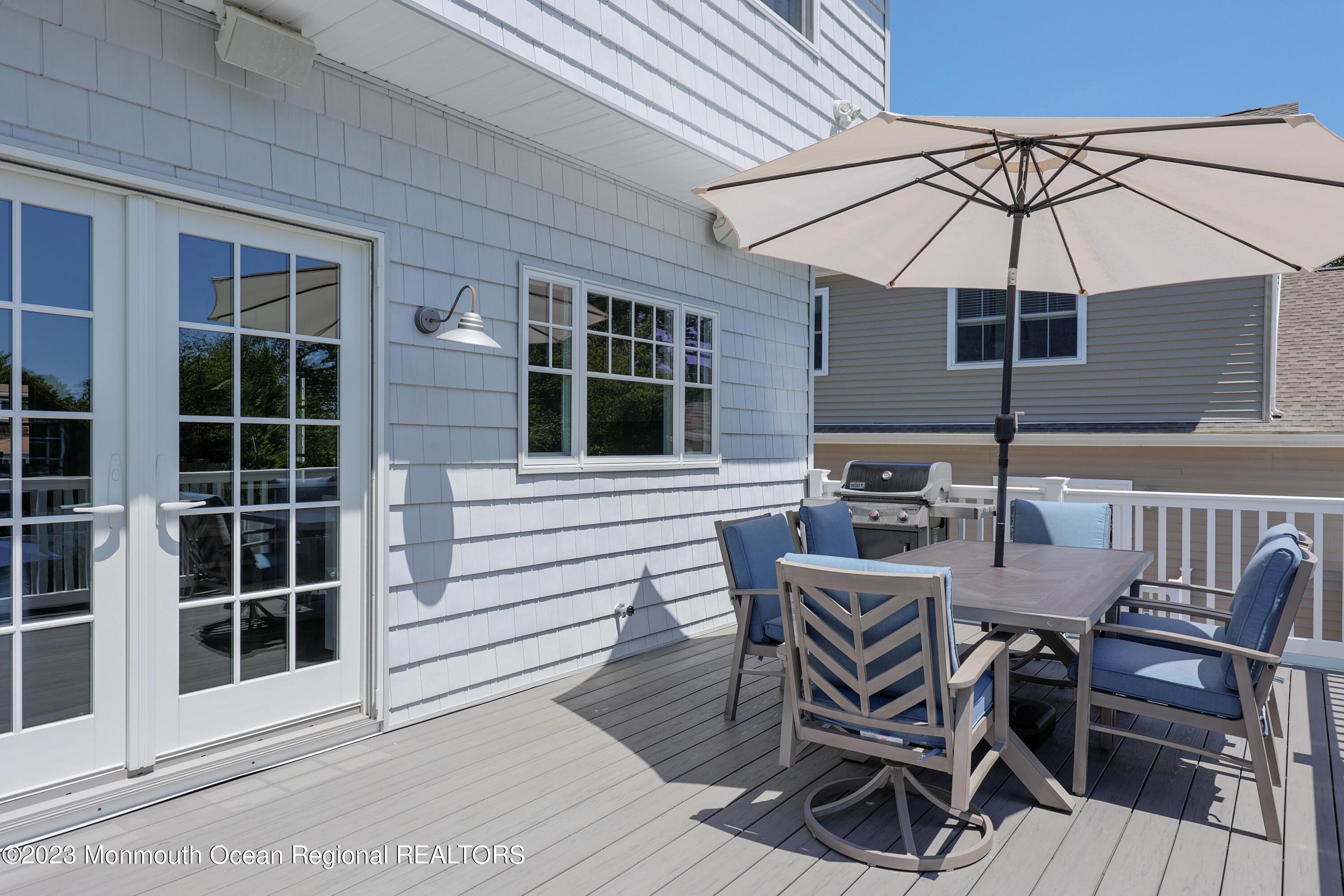 155 Osborn Avenue Bay Head, NJ 08742 - Photo 30 of 55 a view of a patio with table and chairs under an umbrella
