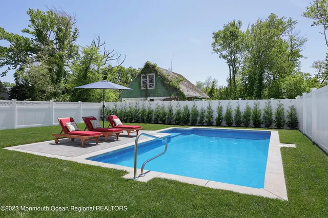 a backyard of a house with table and chairs